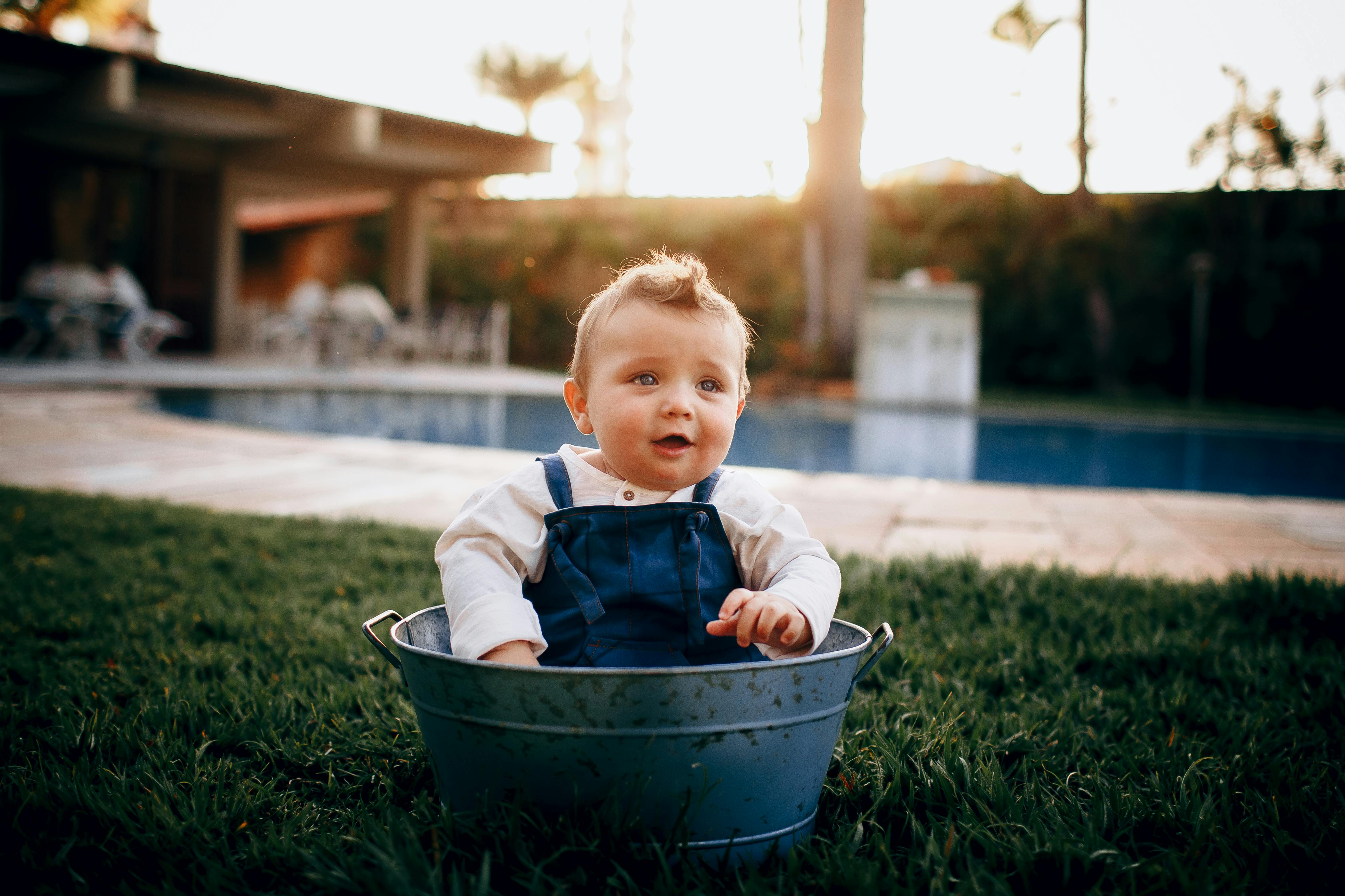 smiling boy in front of a swimming pool