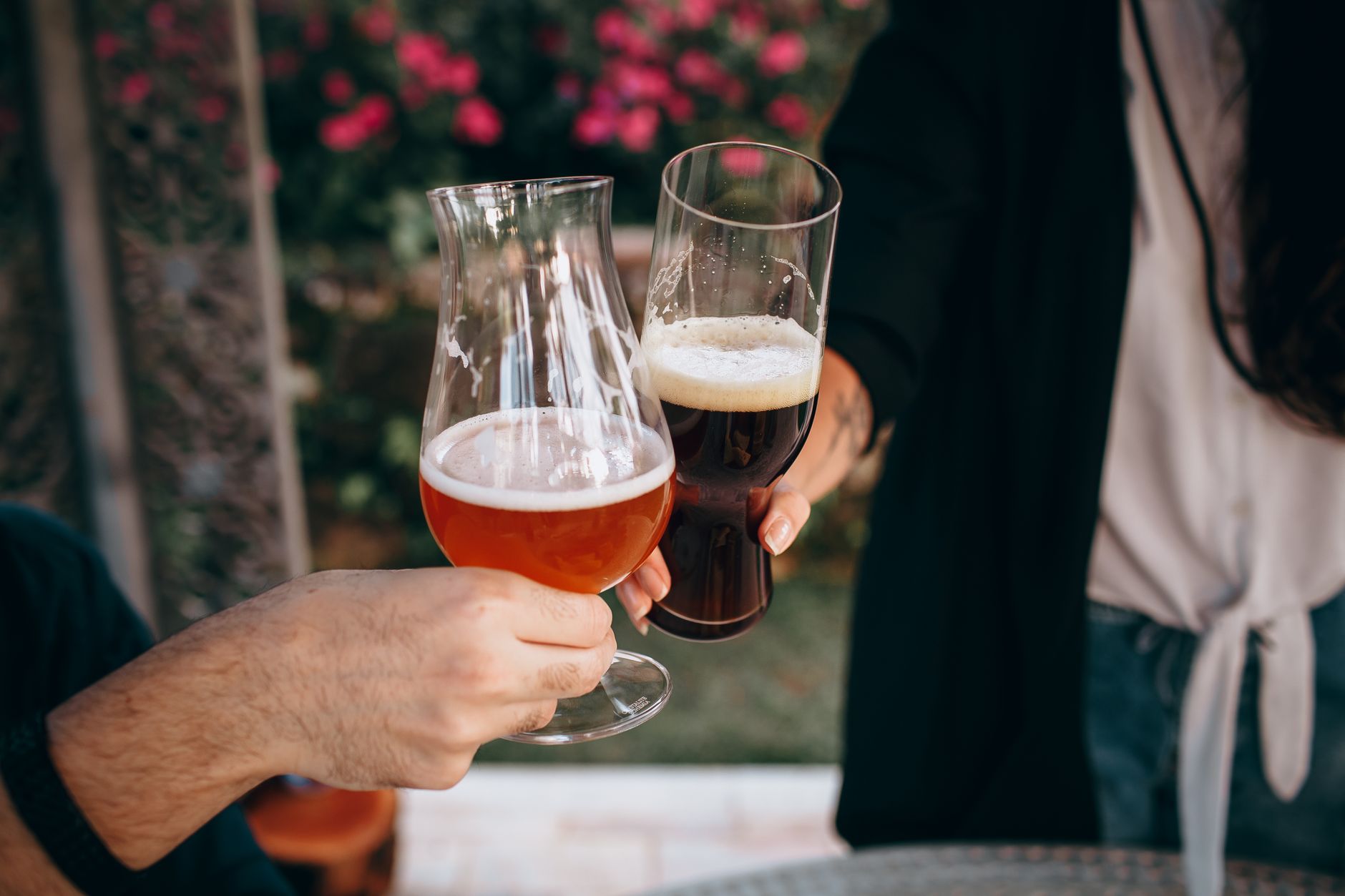 A glass of barley wine ale with rich amber color and creamy foam
