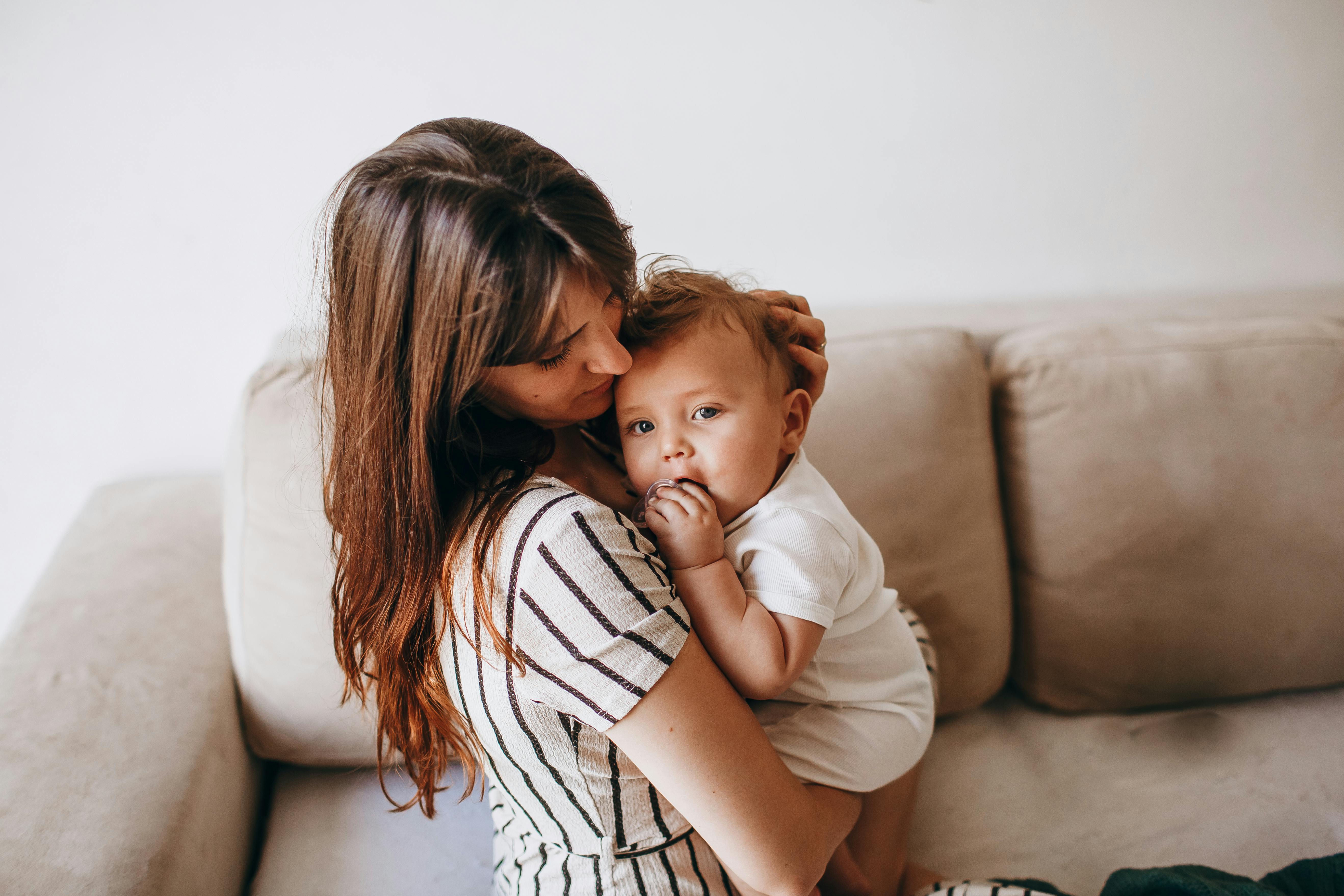 mother with baby on sofa