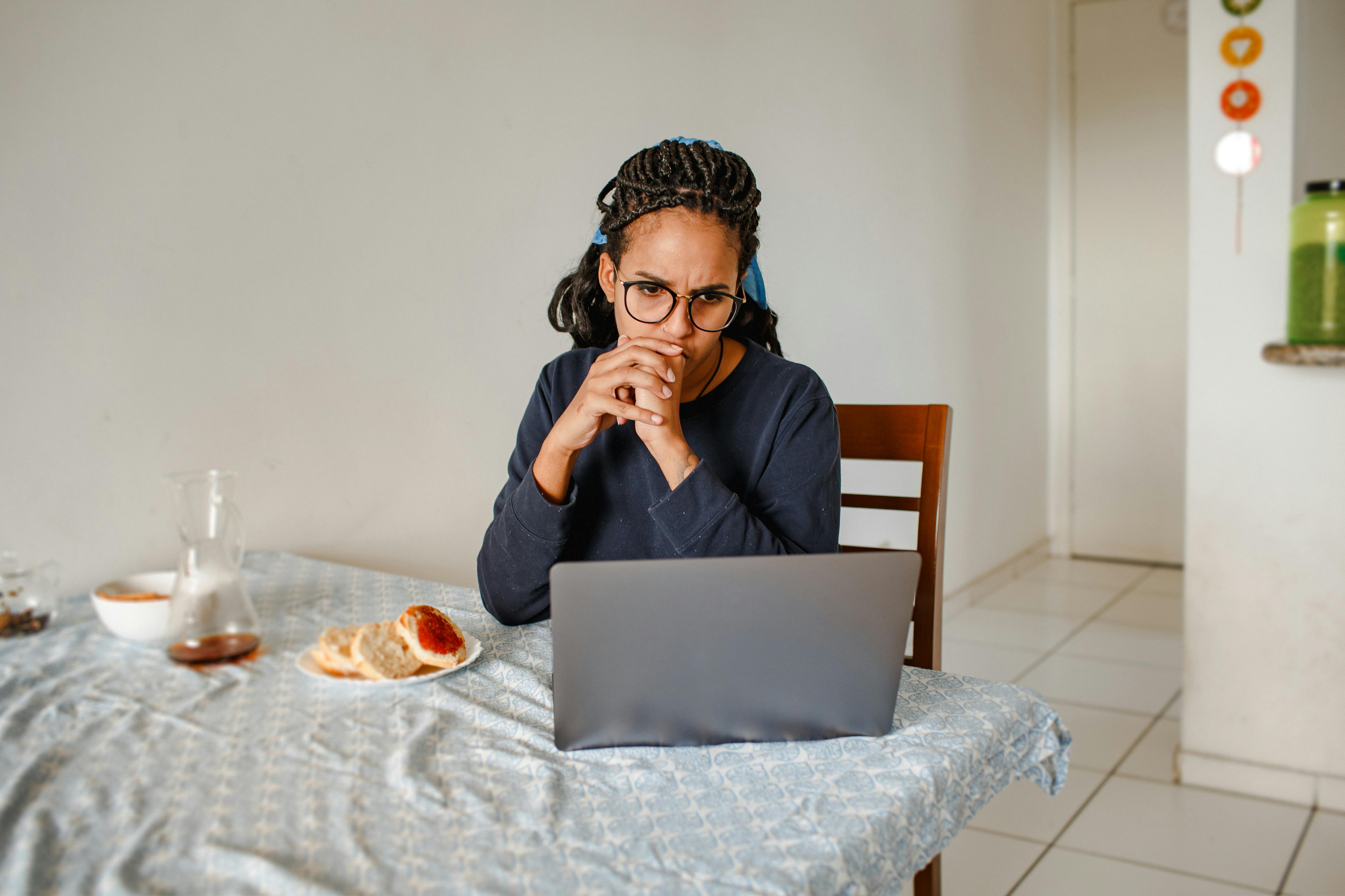 woman watching laptop during breakfast