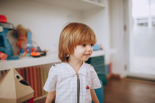 Free A cute young boy enjoying his time playing indoors in a vibrant playroom setting. Stock Photo