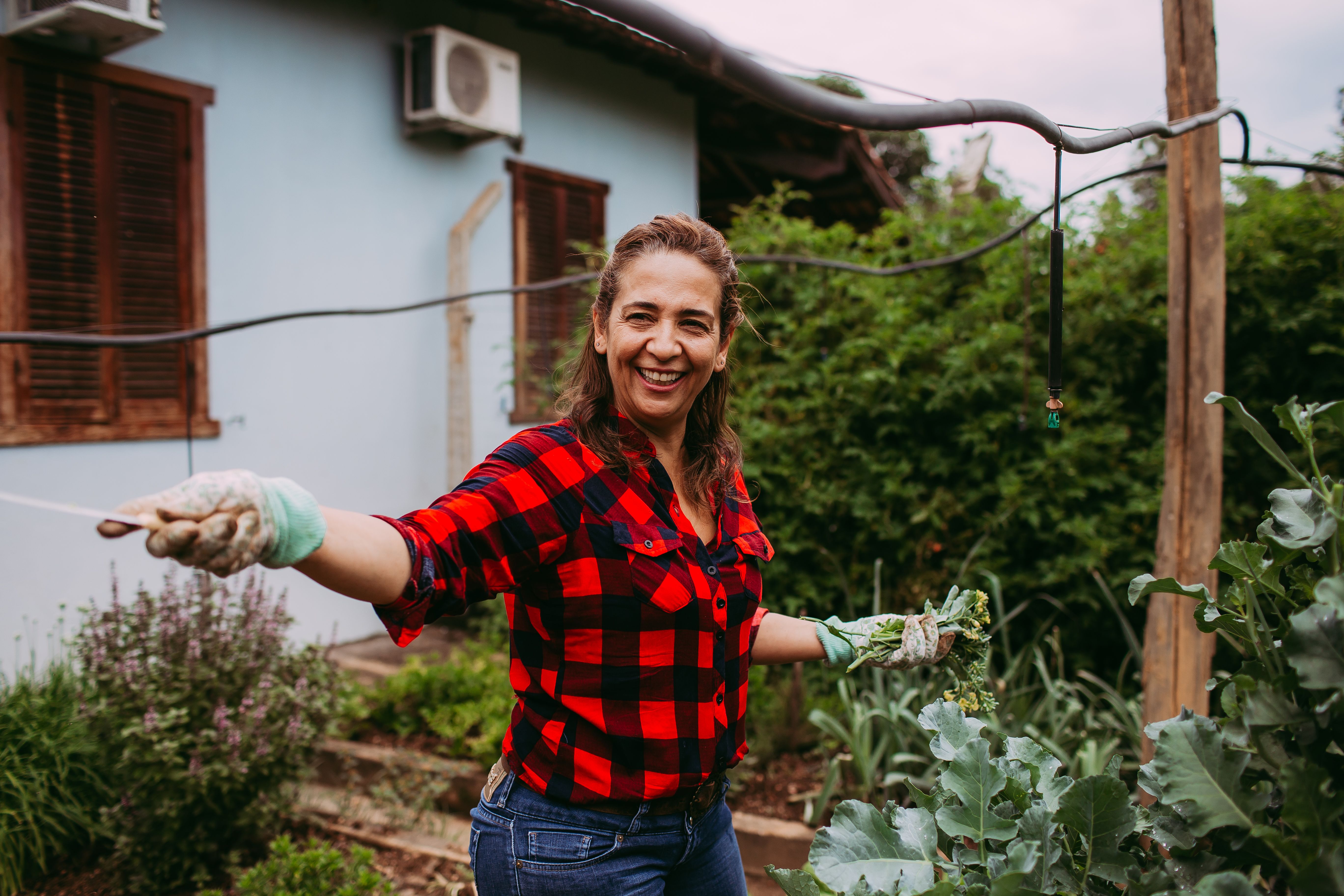 happy gardener watering broccoli raab