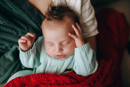 Free A serene newborn baby sleeps comfortably wrapped in cozy blankets, warmly dressed indoors. Stock Photo