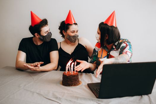 Friends celebrating a birthday with masks and virtual connection.