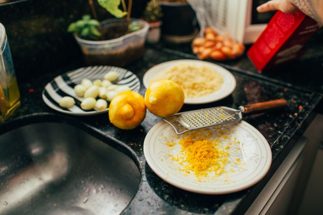 Lemons and grated citrus zest on a plate — photo by Helena Lopes on Pexels