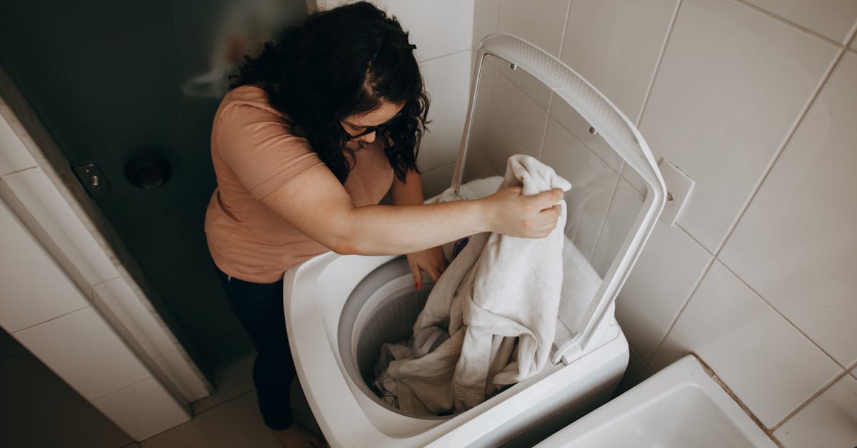 Woman washing clothes in a washing machine