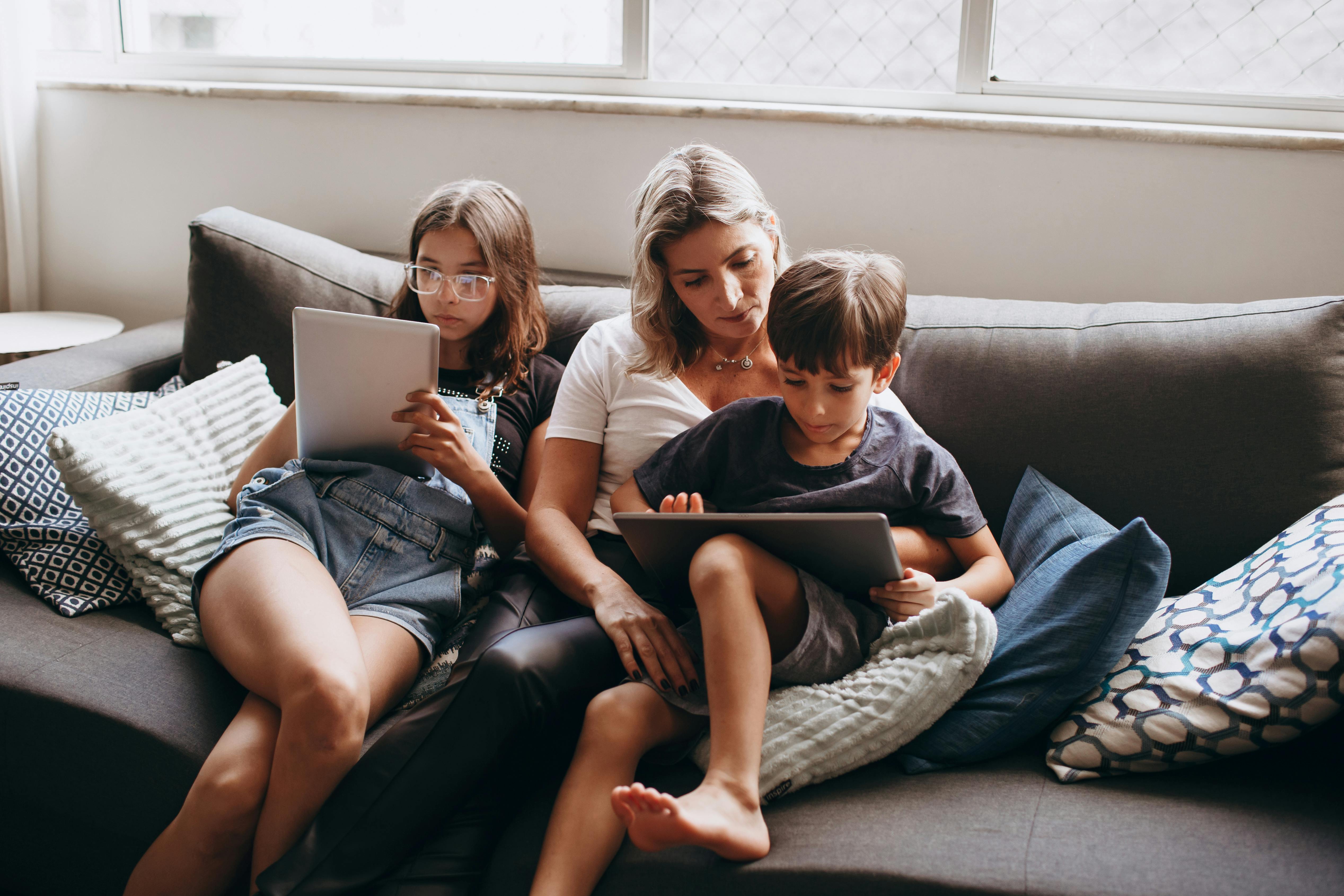 mother and children sitting on couch