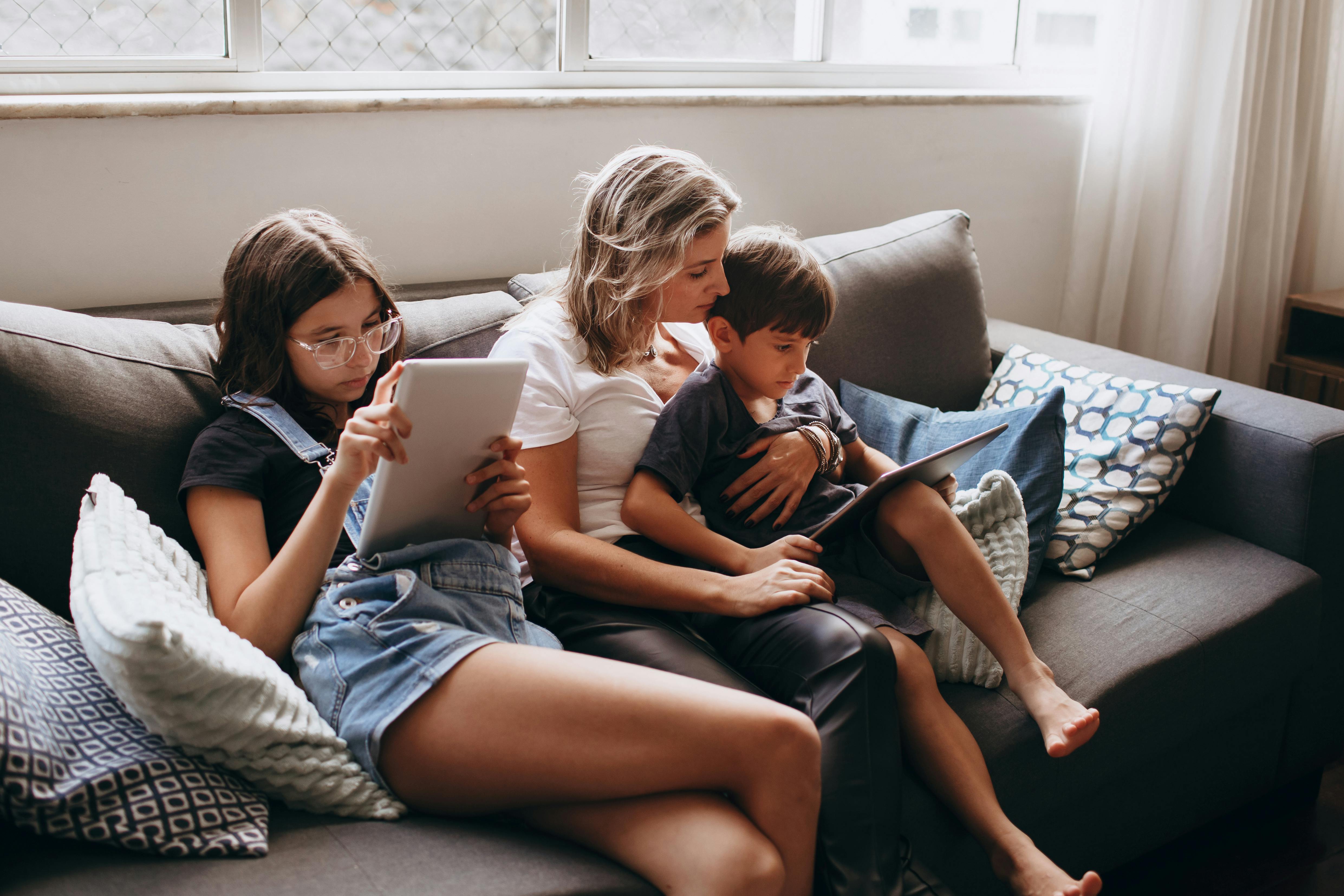 Children Sitting with Mother on Couch · Free Stock Photo, image size:1125x750