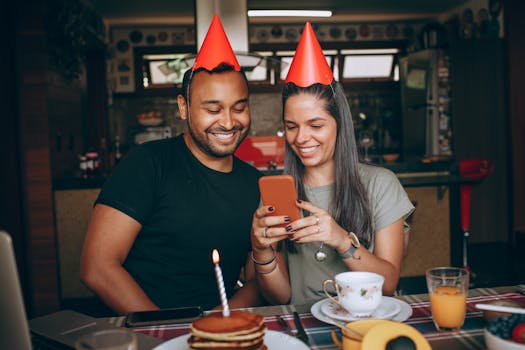 Happy friends celebrating a birthday with cake and festivities indoors.