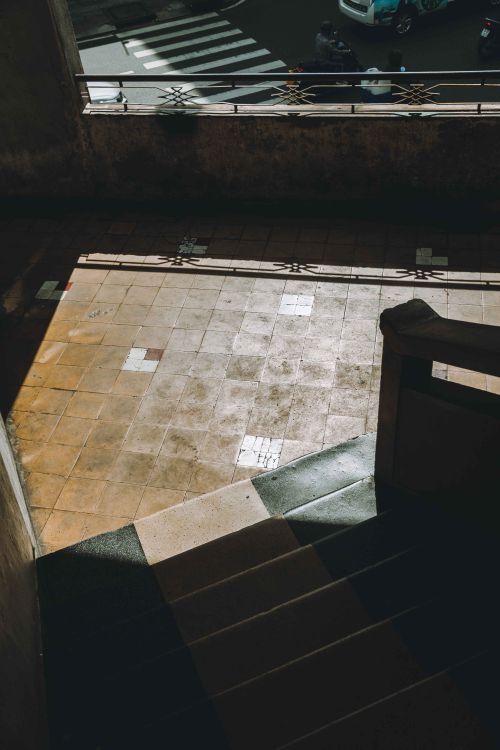 Free View from shadowed staircase of street with crosswalk in Ho Chi Minh City, Vietnam. Stock Photo