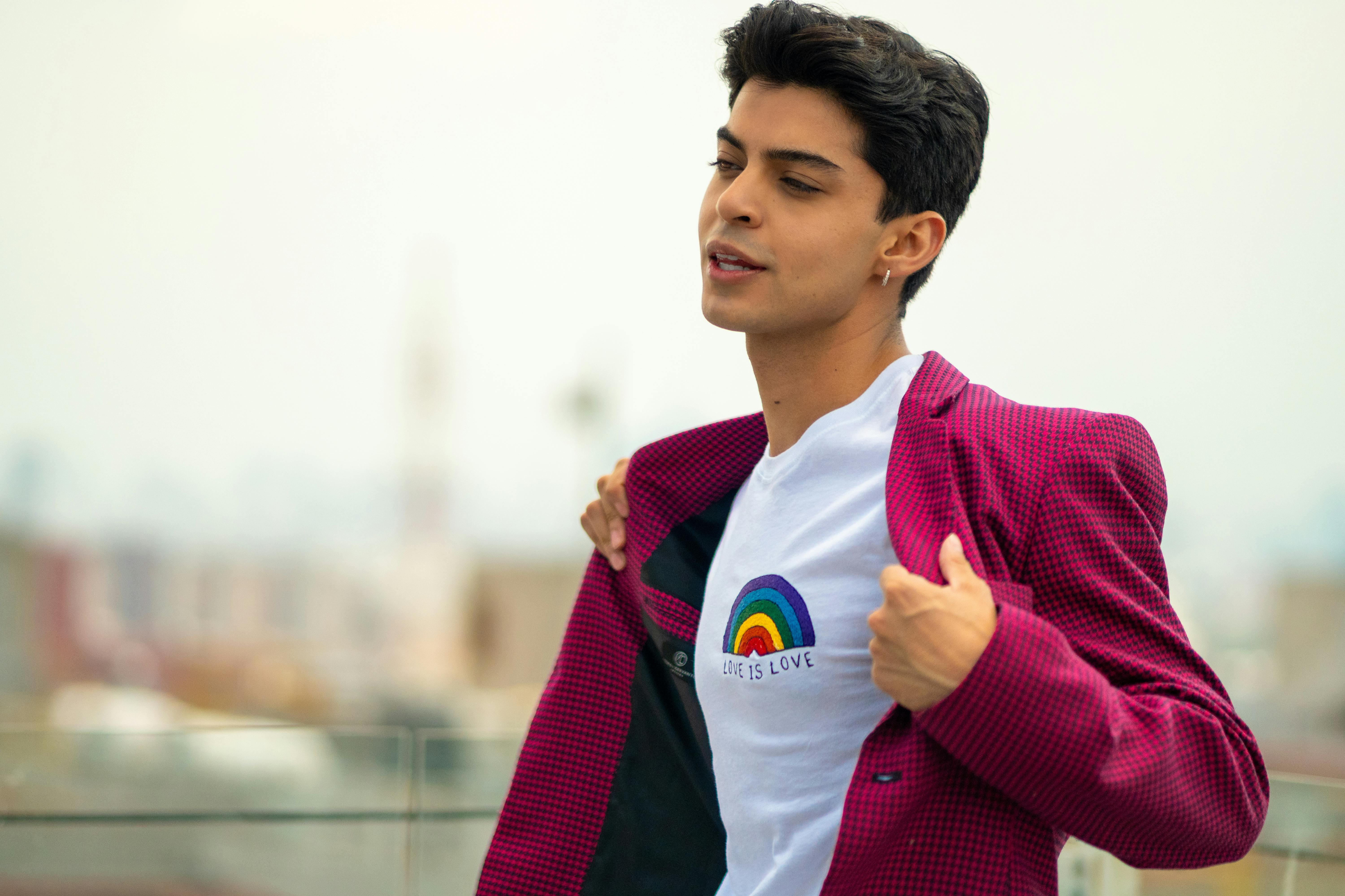 man exposing shirt with rainbow print