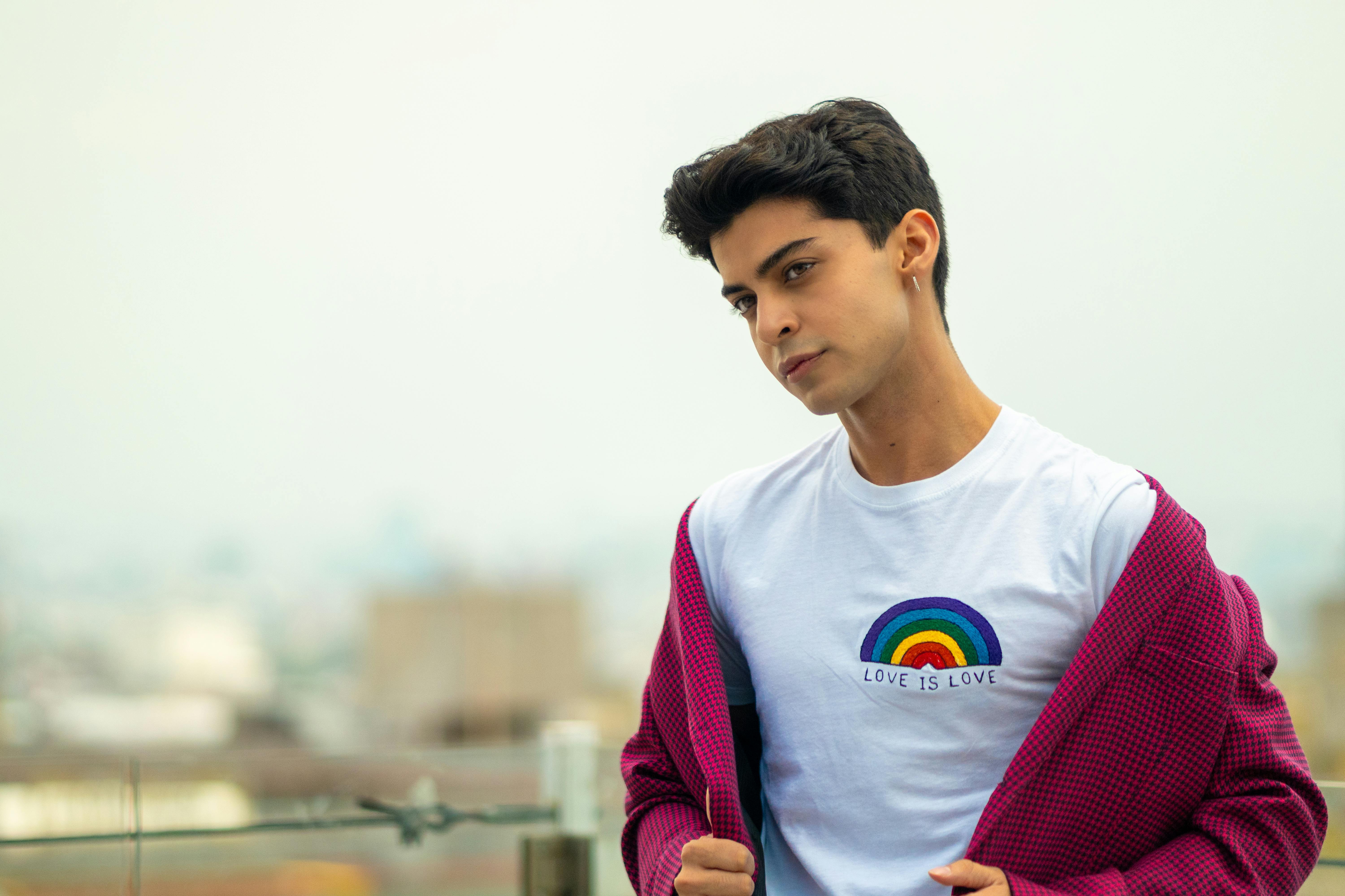 man wearing rainbow print shirt