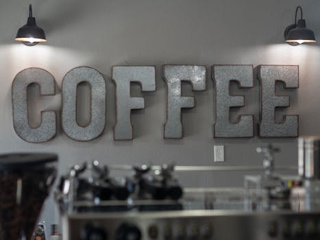 Industrial coffee shop decor with a large metal 'COFFEE' sign and modern details.