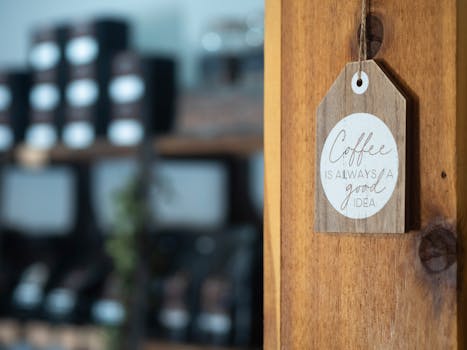 Warm coffee shop interior featuring a wood sign with uplifting message, perfect ambiance capture.