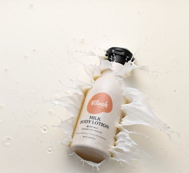 Creative shot of milk body lotion with a splash effect for a fresh and hydrated feel.