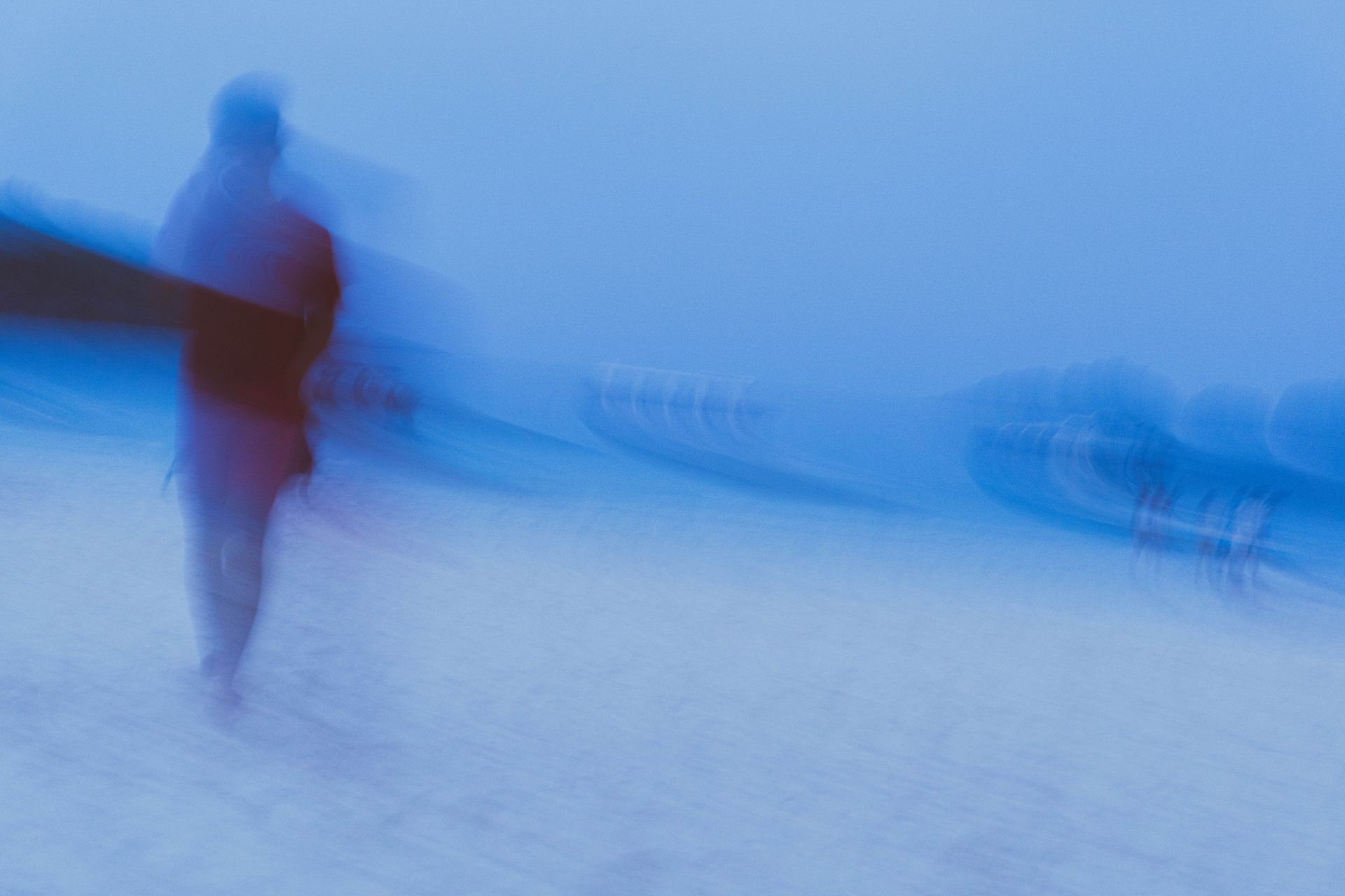 Blurry Photo of a Person Standing on a Beach