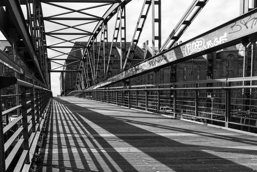 Free A black and white photo of a steel bridge in Hamburg's warehouse district. Stock Photo
