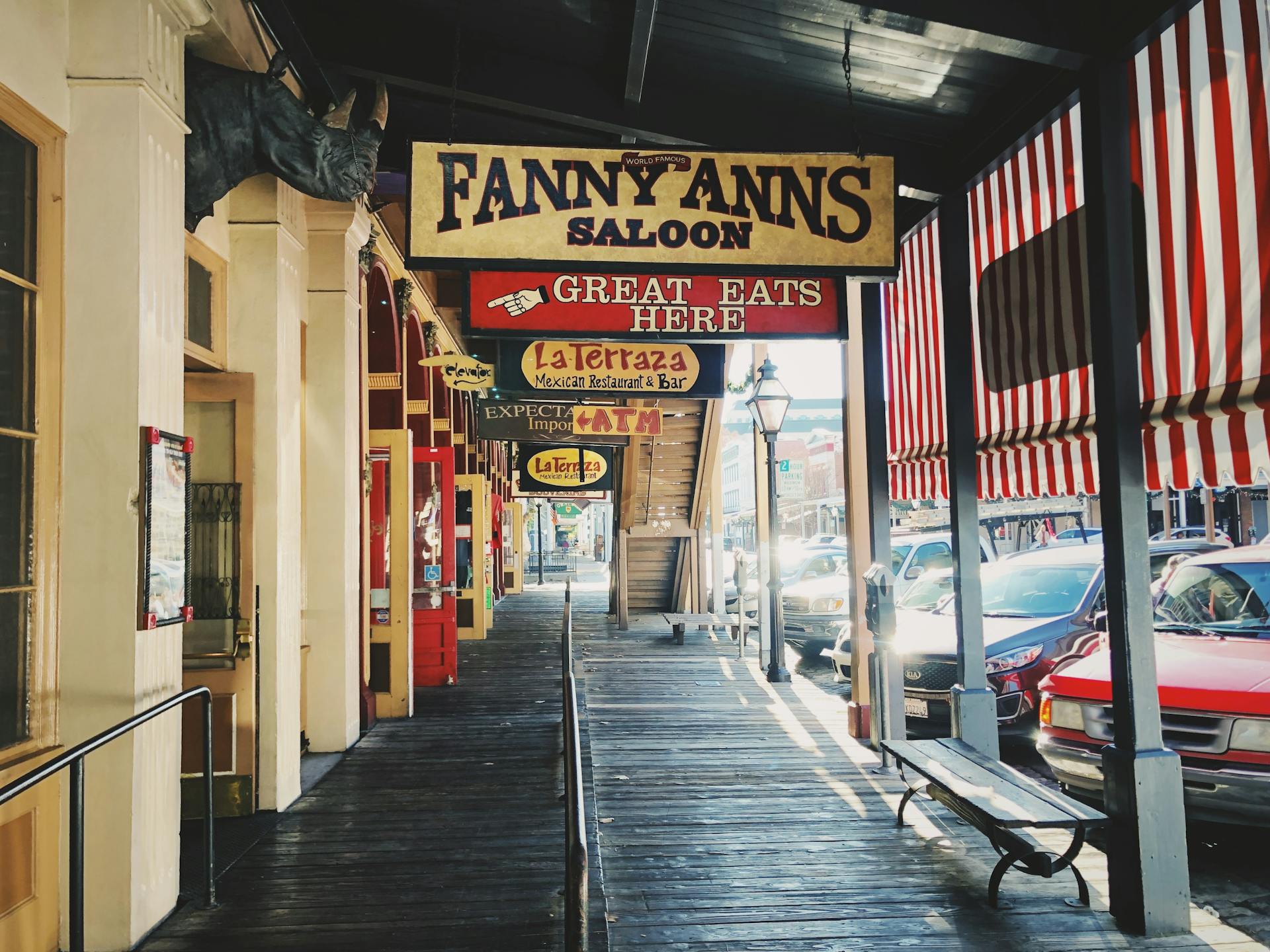 Charming street view featuring iconic Western saloon signs in a historic town.