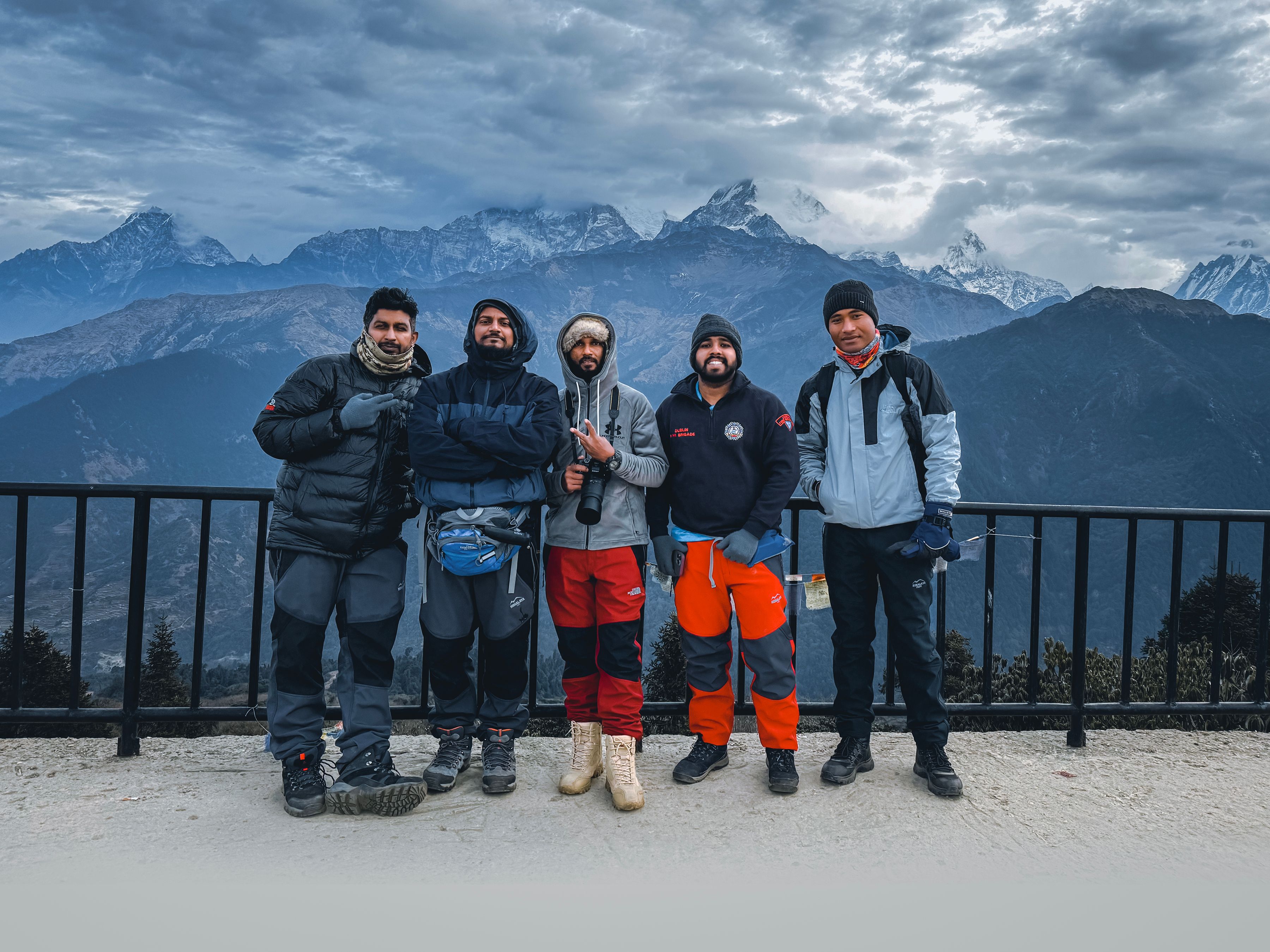 Group of trekkers enjoying a winter hike in Ghode Pani, Nepal with majestic mountain views.
