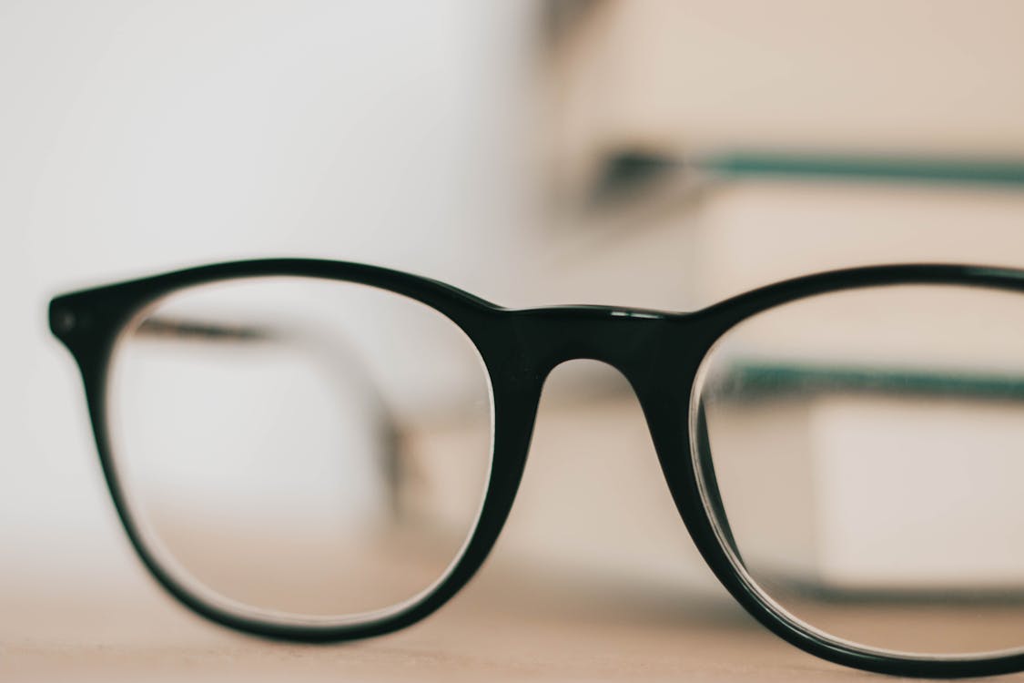Black Framed Eyeglasses on White Surface