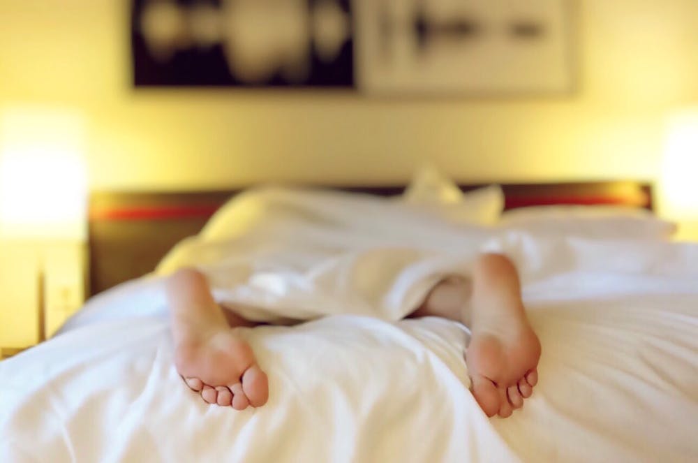Person lying on the bed. | Photo: Pexels