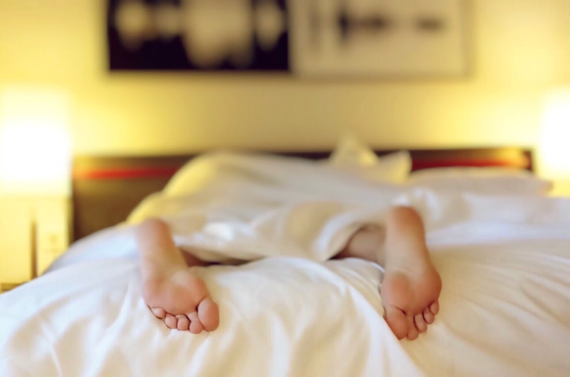 Person Lying on Bed Covering White Blanket