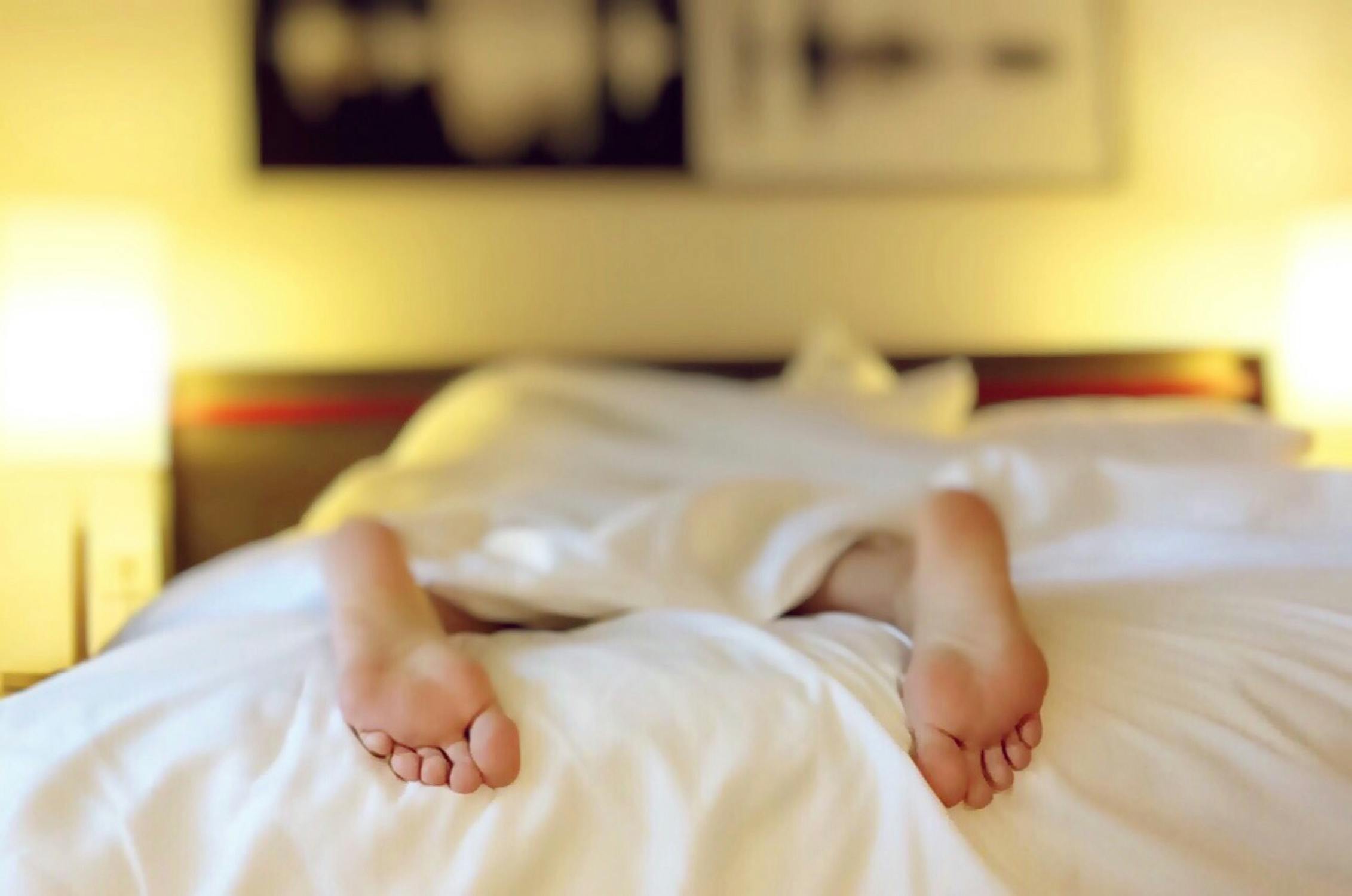 Person lying in hotel bed.