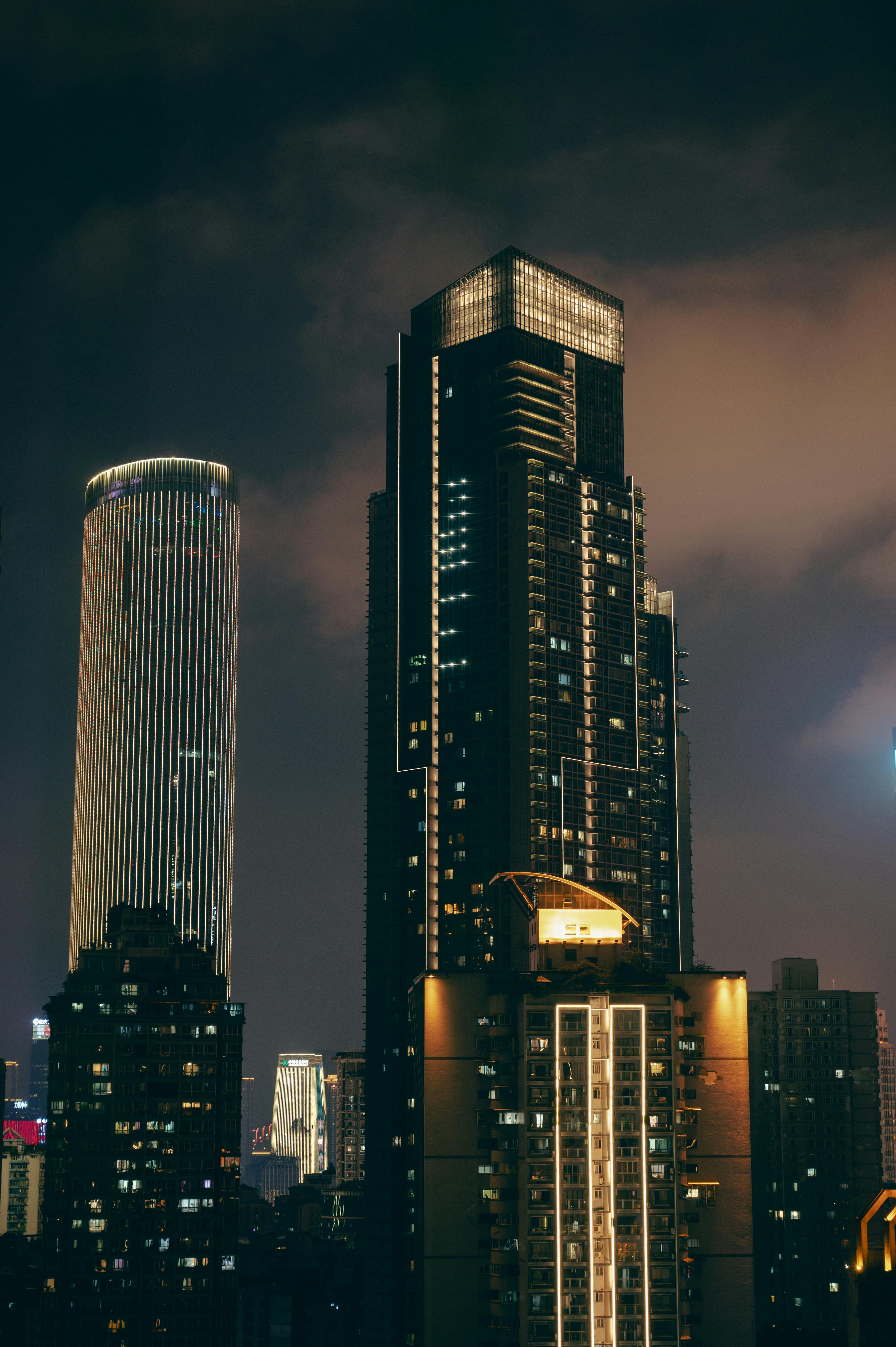 A stunning view of illuminated skyscrapers in a cityscape at night.