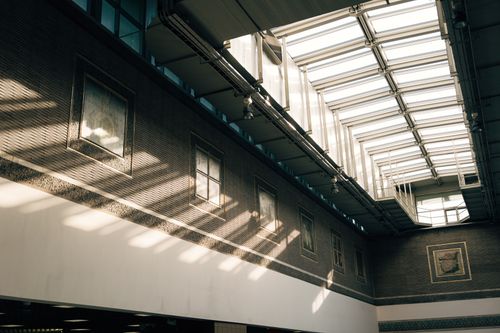 Free Illuminated indoor space with modern skylight and architectural elements casting shadows. Stock Photo