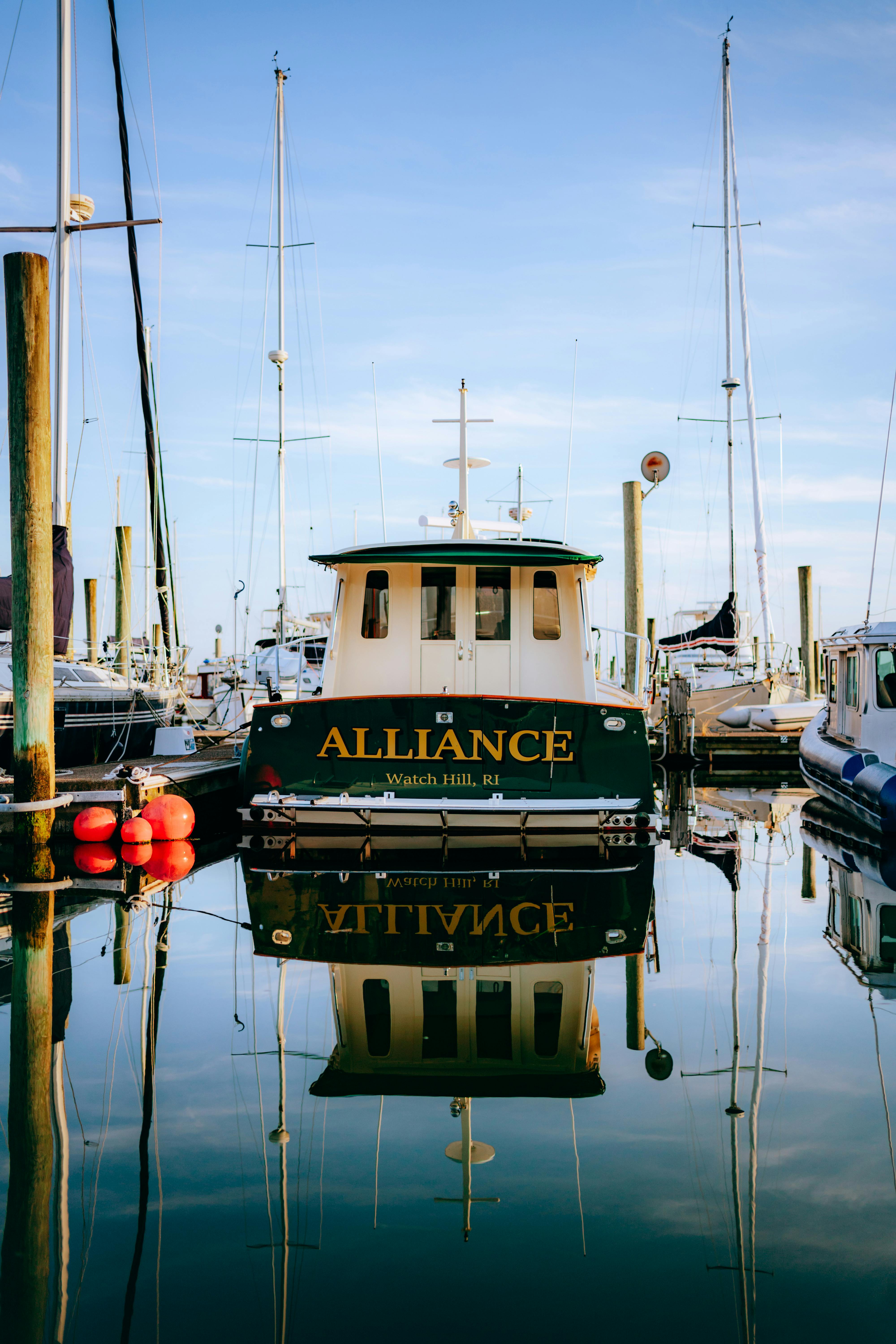 The boat 'Alliance' moored at Watch Hill, reflecting in calm waters at the marina.