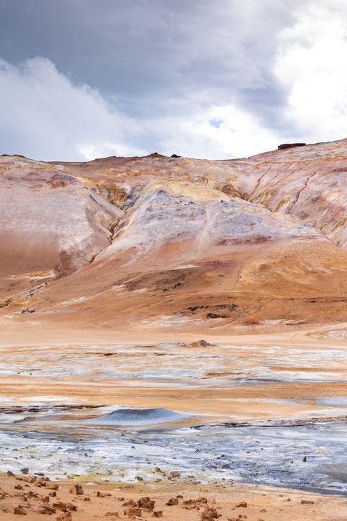 Free Breathtaking geothermal terrain in Akureyri, Iceland, showcasing vibrant earth tones and dramatic clouds. Stock Photo