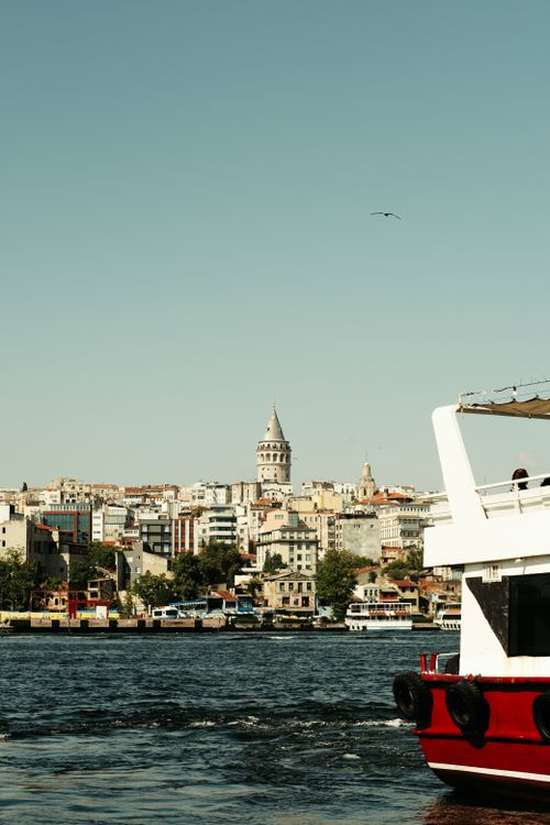 Free View of the iconic Galata Tower and bustling waterfront in Istanbul, Türkiye. Stock Photo