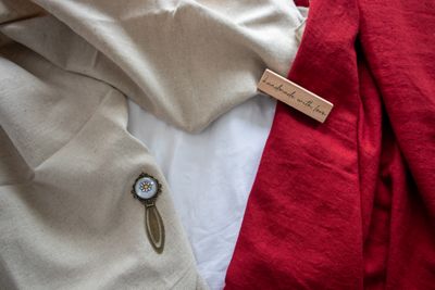 Oatmeal and madder-red cloth with a stitched maker's tag — photo by Rita K on Pexels