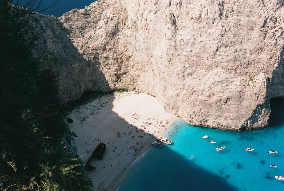 A stunning aerial shot of Navagio Beach with turquoise waters and rugged cliffs in Zakynthos, Greece.