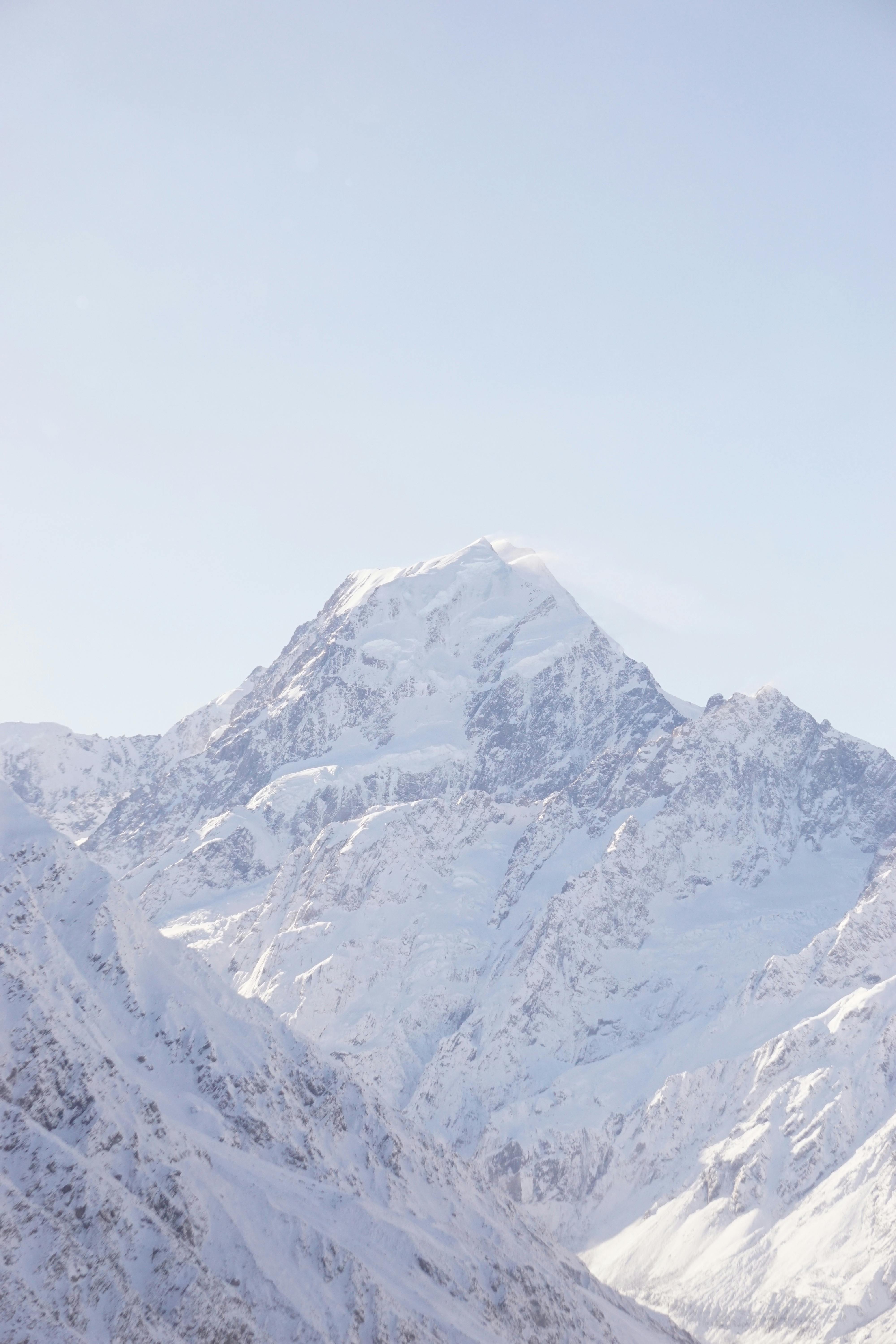 A breathtaking view of Aoraki / Mount Cook covered in snow, showcasing New Zealand's stunning winter landscape.