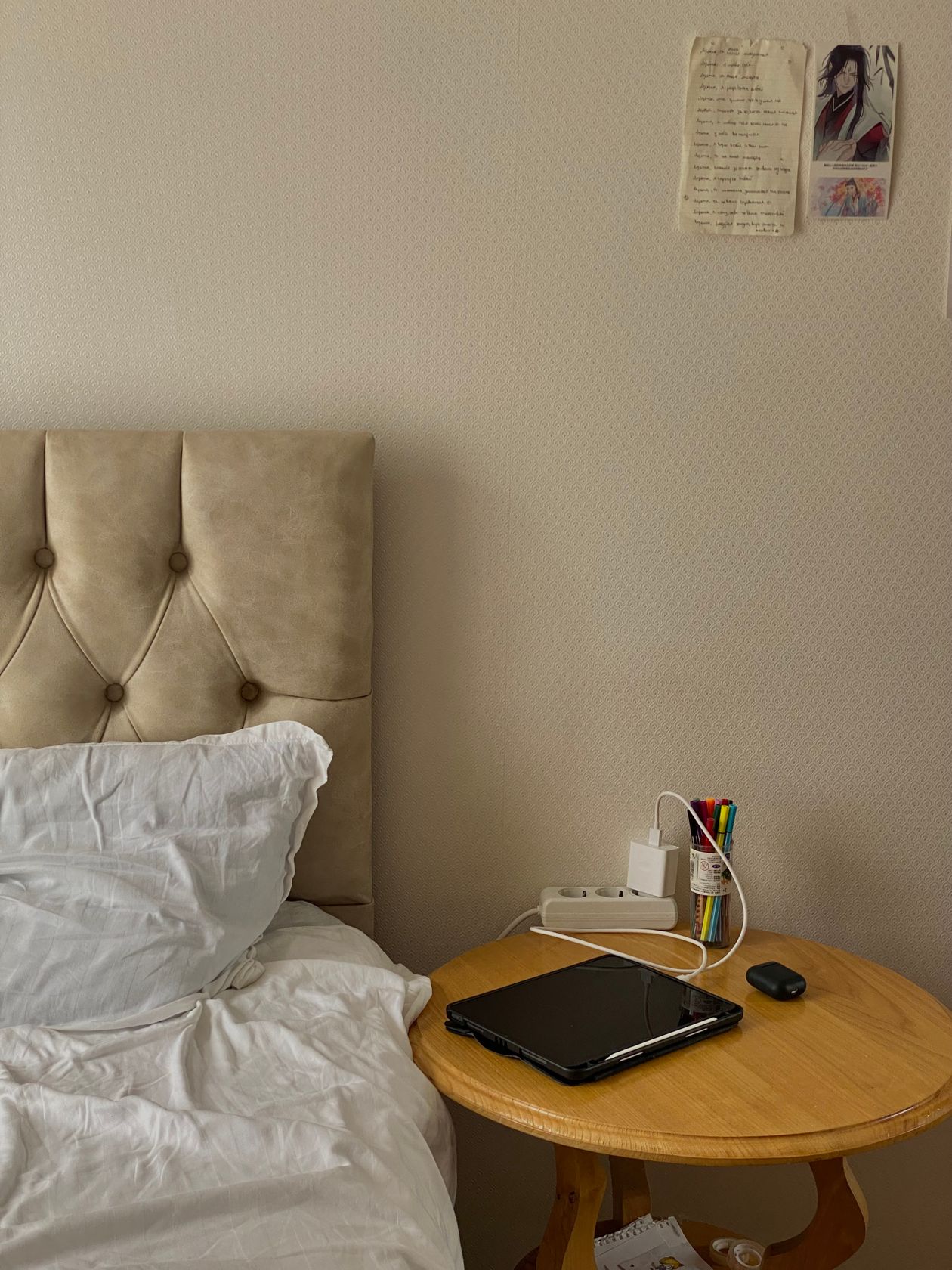 Daily-use caddy holding chargers and keys in a tiny bedroom.