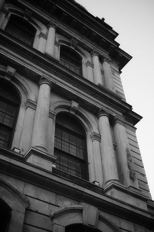 Free Close-up of a classic architectural facade with columns in black and white. Stock Photo