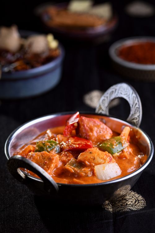 Free A mouth-watering chicken curry dish with colorful vegetables in an ornate bowl. Stock Photo