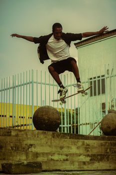 A skateboarder executes a trick mid-air at a skatepark in Lagos, Nigeria.. skateboarder, executes, trick