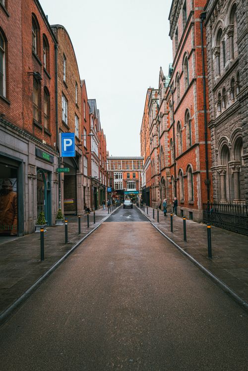 Free Explore a narrow street lined with historic brick buildings in Dublin, Ireland, showcasing urban architecture. Stock Photo