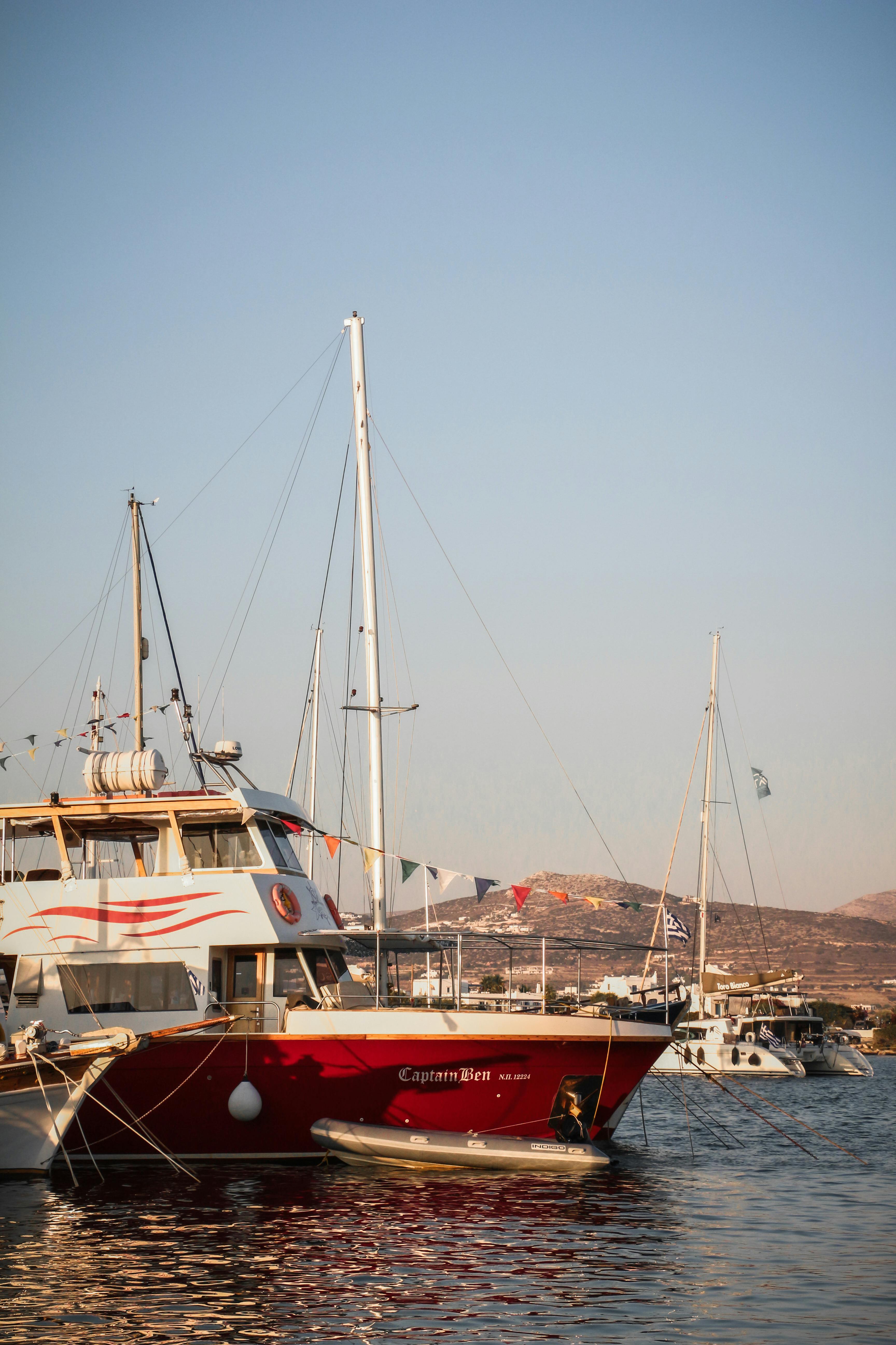 Vibrant boats docked in the serene harbor of Paros under a clear summer sky.