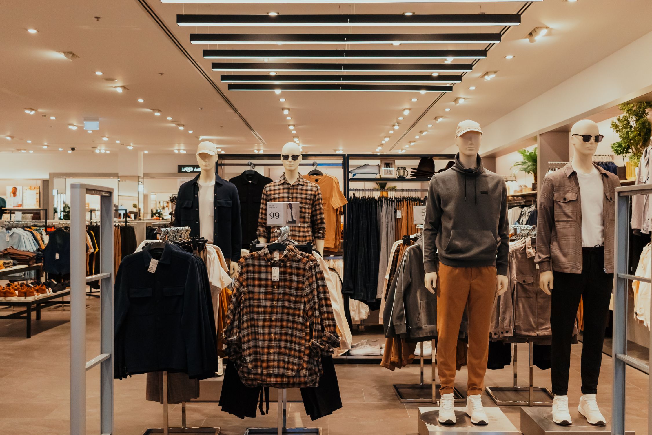 A retail shopping store with a lot of clothing and manikins · Free ...
