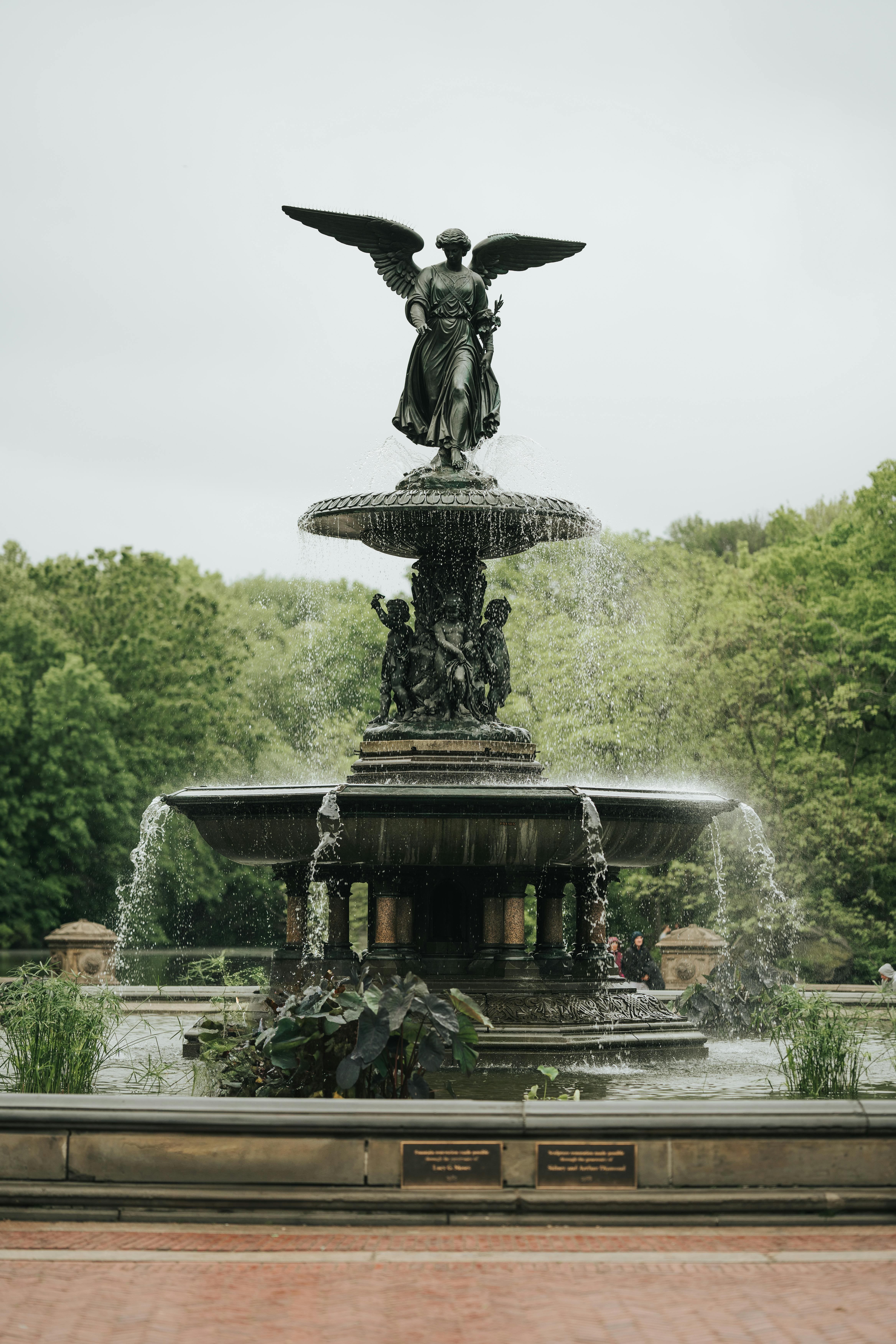 The Angel of the Waters fountain in Central Park, a famous landmark surrounded by lush greenery.