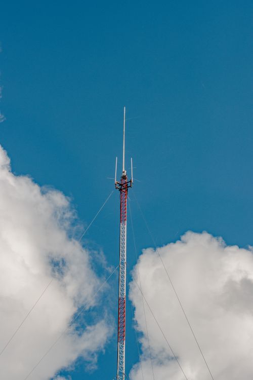 Free A tall communication tower reaching into the clouds in Chillán, Ñuble, Chile. Stock Photo