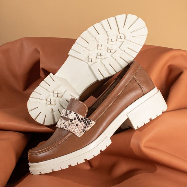 Brown leather loafers on terracotta cloth, by José Martin Segura Benites on Pexels