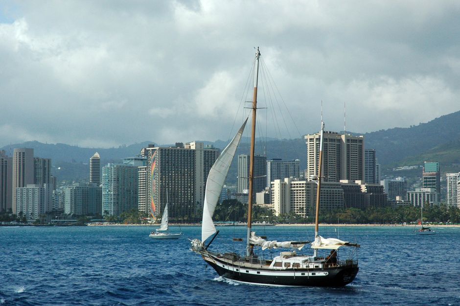 Stunning Exceptional Maui Whale Watch Review: A Luxury Encounter with Hawaii's Giants Review 2026 - A scenic view of a sailboat cruising near the skyline of Honolulu, Hawaii.