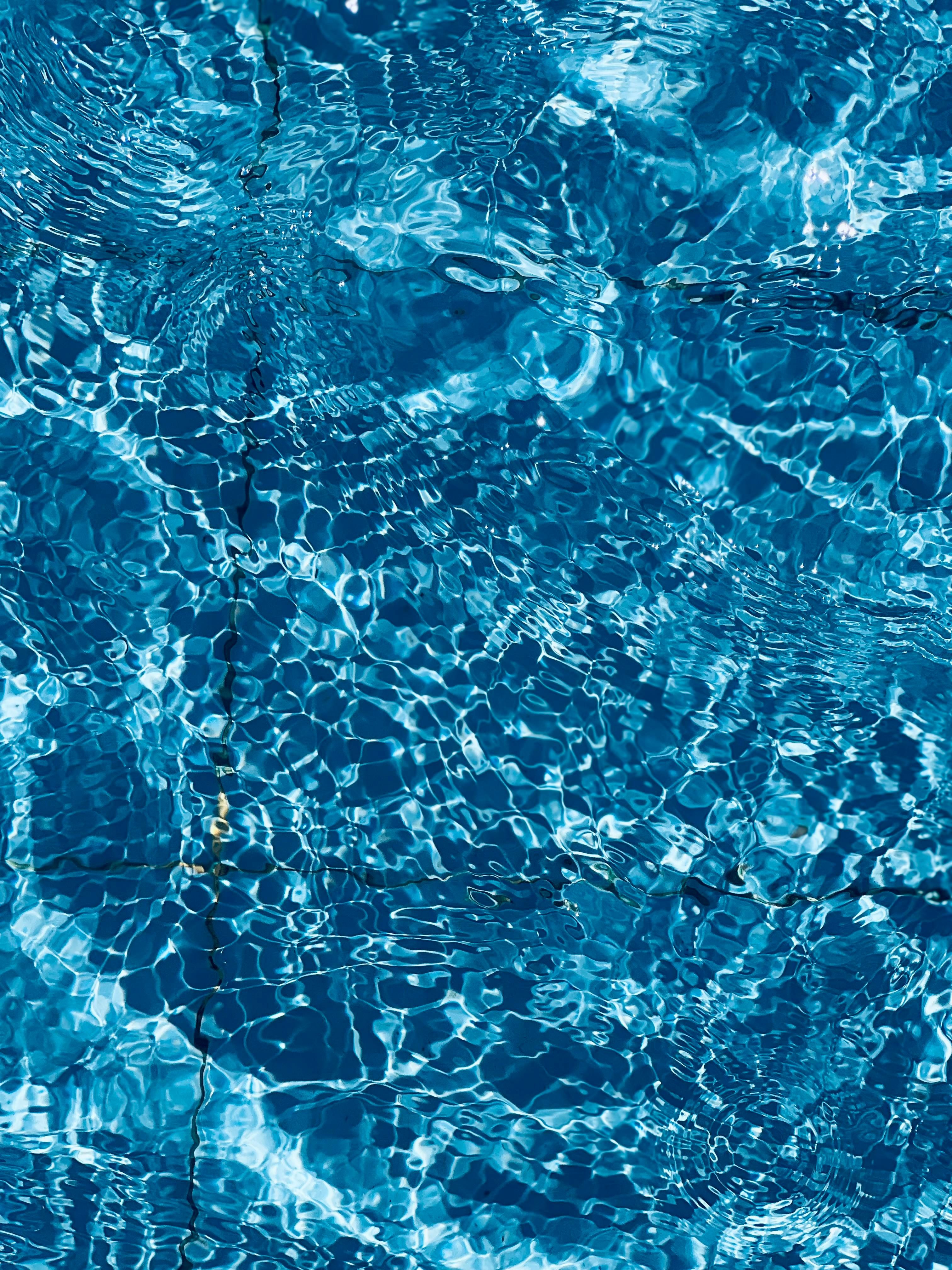 Vibrant blue water ripples create an abstract, calming background pattern.