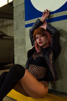 Stylish punk-inspired woman posing with urban graffiti in Mexico City.