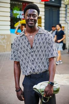 Fashionable man in casual shirt smiling outdoors in Marseille, France.