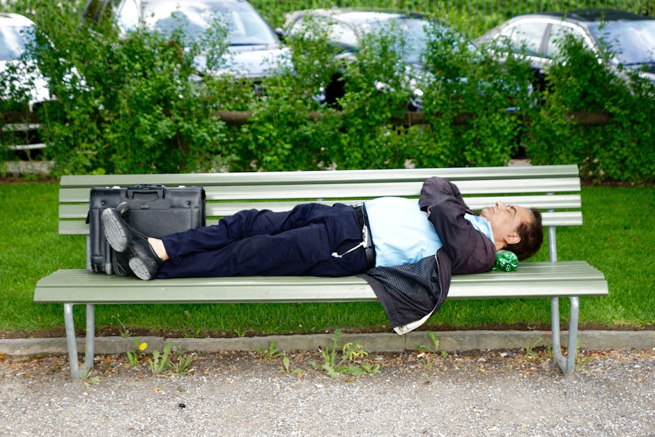 Man Sleeping on Gray Bench